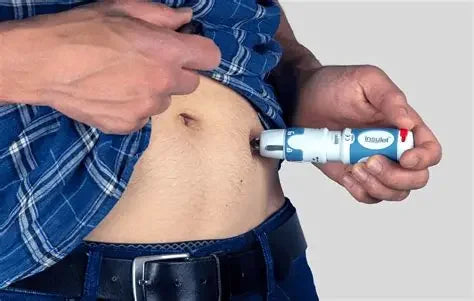 Person using an insulin pen injector for subcutaneous injection in the abdomen