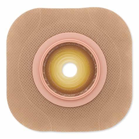 Beige ostomy barrier wafer for colostomy or ileostomy, adhesive medical dressing.