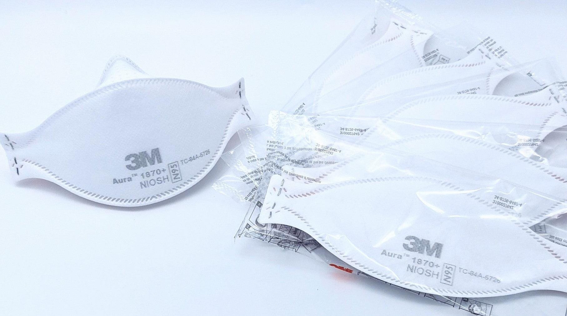 3M Aura 1870+ N95 respirator masks, single and in sealed packs, on white background