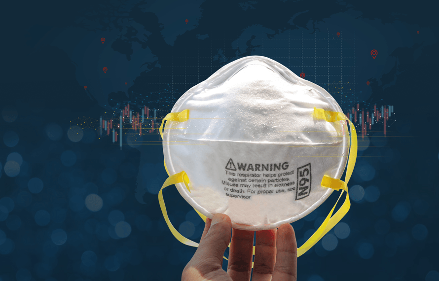 Hand holding N95 respirator face mask with yellow straps, medical supplies background