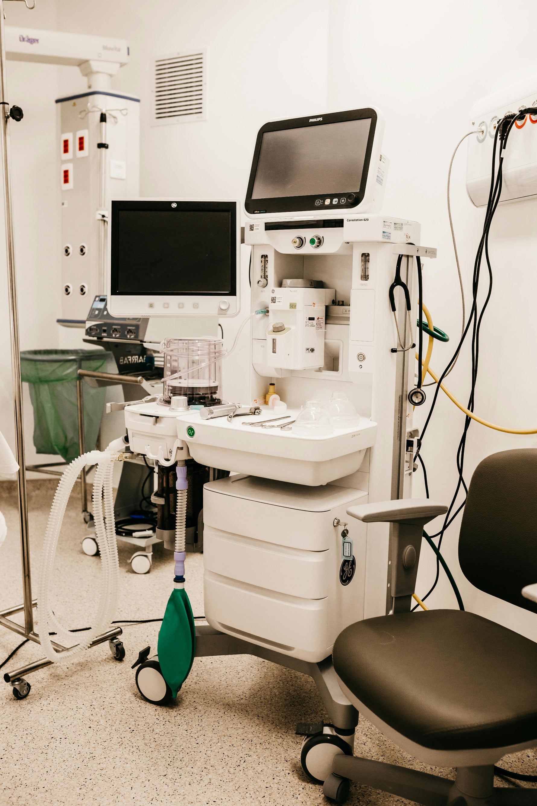 Medical equipment including ventilator, monitors, and oxygen supplies in a clinical setting for respiratory care.