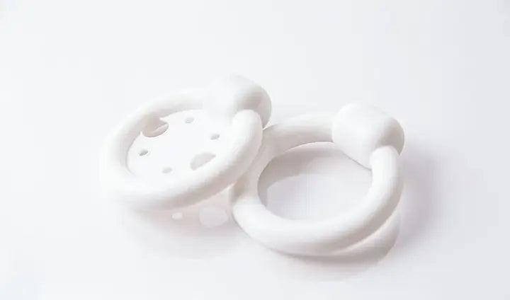 Two white medical pessary rings on a clean white background