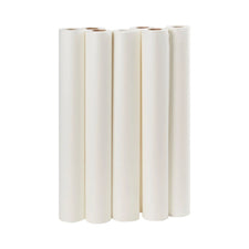 Six rolls of white medical examination table paper standing upright on a white background
