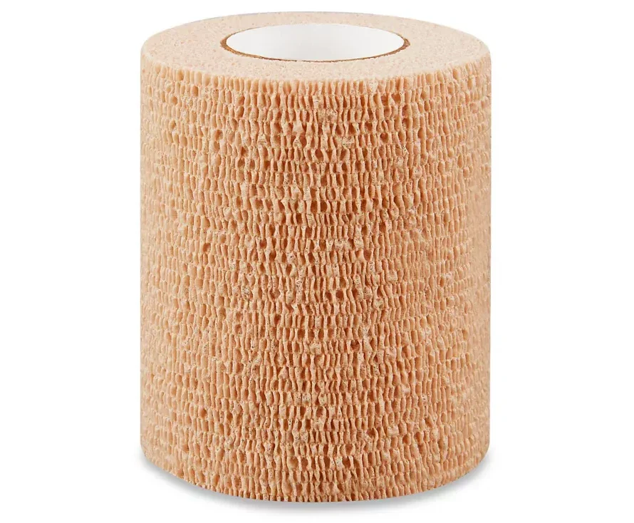 Beige self-adhesive medical bandage roll for wound care and injury support
