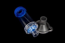 Clear plastic medical spacer device with blue cap and detachable mask on black background