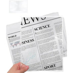 Hand holding flexible magnifying sheet lens over newspaper text for reading aid