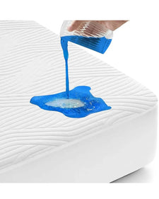 Waterproof mattress protector tested with blue liquid spill on white bed cover