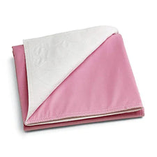 Pink reusable underpad with white quilted absorbent layer, folded for home care use