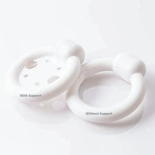 Two white medical pessary rings, one with support and one without, on a white surface