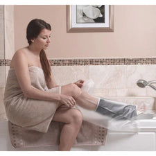 Woman in bathroom using waterproof leg cast cover for shower protection