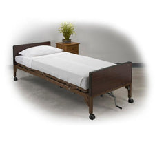 Adjustable medical hospital bed with wheels and white bedding in a home care setting