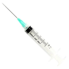 Disposable single-use syringe with measurement markings and needle on white background