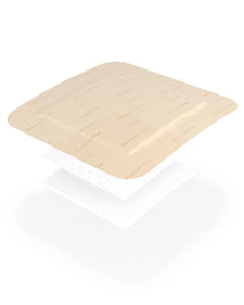 Layered view of a beige medical wound dressing pad, showing multiple breathable layers