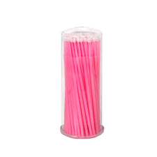 Pink cotton swabs in a clear plastic cylinder container for esthetic or medical use