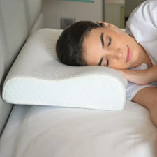 Woman sleeping on orthopedic memory foam pillow for neck support