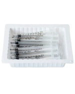 Pack of sterile disposable syringes in a white tray for medical use