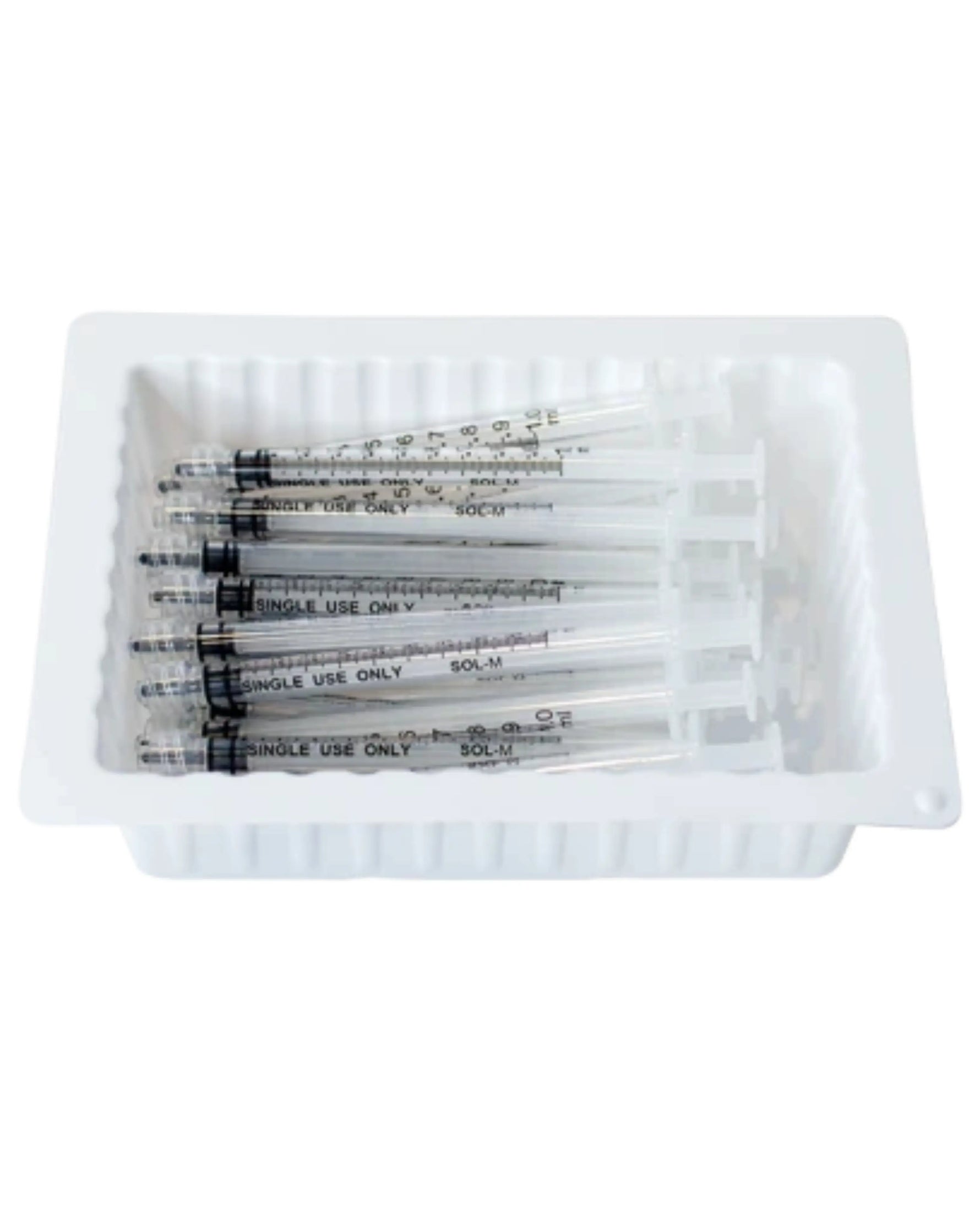 Pack of sterile disposable syringes in a white tray for medical use