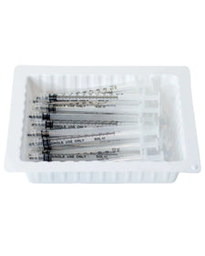 Pack of sterile disposable syringes in a white tray for medical use