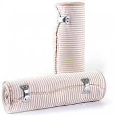 Elastic compression bandages with metal clips for medical use, rolled and standing.