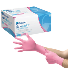 Person putting on pink nitrile medical examination gloves beside glove box