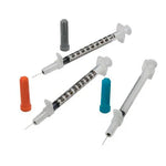 Three medical syringes with measurement markings and assorted needle caps on a white background.