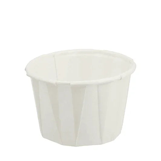 Disposable white paper medicine cup for medical or home care use on white background