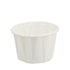 Small white disposable paper medicine cup for medical supplies and home care use