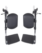 Pair of black wheelchair leg rests with padded calf supports and footplates on white background