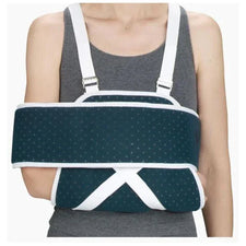 Person wearing orthopedic arm immobilizer sling for injury support