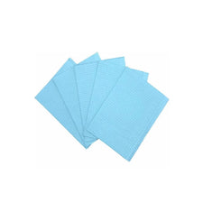 Stack of blue disposable dental bibs on white background, medical supplies