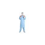 Healthcare worker wearing blue medical gown, face mask, cap, and shoe covers on white background