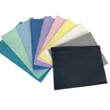 Assorted disposable dental bibs in multiple colors, ideal for medical and home care use