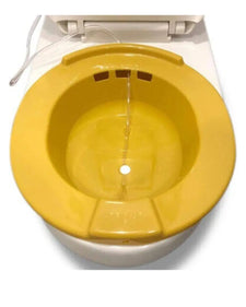 Yellow plastic sitz bath basin on toilet with water flowing, home care medical supply