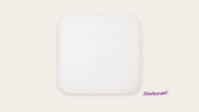 Square white foam wound dressing with rounded corners, Safetac medical pad on light background