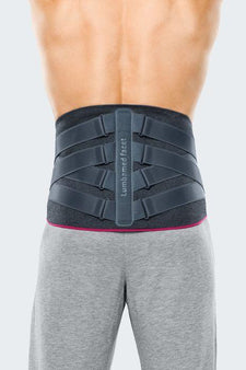 Back view of a person wearing a black adjustable lumbar back support brace for pain relief