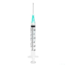 Disposable medical syringe with clear barrel and green needle cap on white background