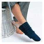 Sock aid device helping person put on navy sock, elderly home care mobility aid
