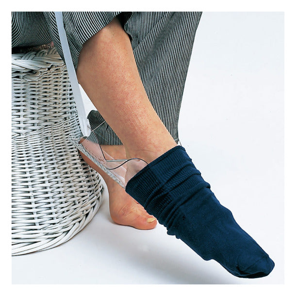 Sock aid device helping person put on navy sock, elderly home care mobility aid