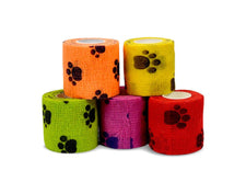 Colorful self-adhesive bandage rolls with paw print patterns for pet care or medical use