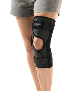 Adjustable black knee brace with open patella design worn on a person's leg for joint support