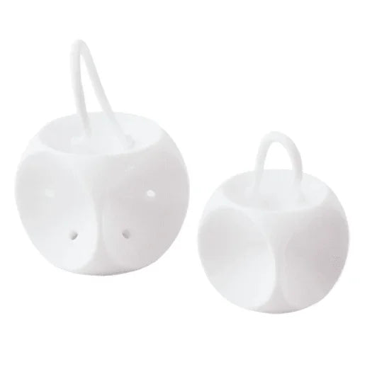 Two white plastic oxygen mask diffuser balls with attached elastic loops, on white background