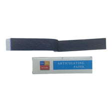 Articulating paper pack with opened dark sheet for dental bite marking on white background