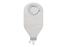 Ostomy drainage bag with adhesive ring for home care and medical use on grey background