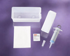 Medical irrigation kit with plastic tray, syringe, tip, antiseptic pad, and gauze on purple background