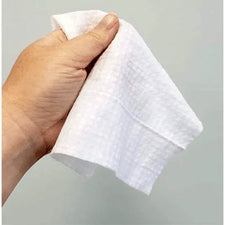 Hand holding an unscented baby wipe for sensitive skin, white textured cloth