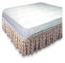 Waterproof mattress protector on hospital or home care bed with floral bed skirt