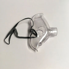 Clear adult oxygen mask with elastic strap on white background, respiratory medical supply