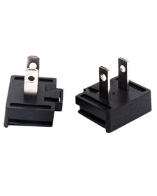 Black two-prong electrical plug adapters for medical equipment on white background