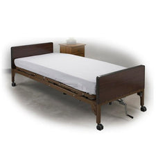 Fitted white medical bed sheet on hospital bed with wooden headboard and caster wheels