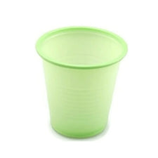 Green disposable plastic medicine cup for home care and medical use on white background